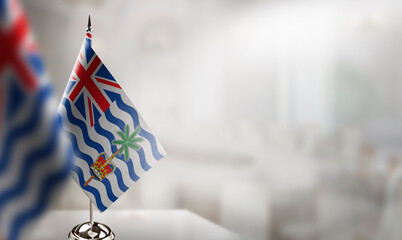 Small flags of the British Indian Ocean Territory on an abstract blurry background