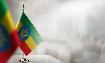 Small flags of the Ethiopia on an abstract blurry background