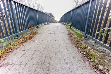 small metal pedestrian bridge over the river
