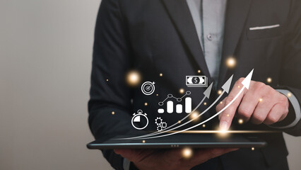 start up business planning concept, business man wearing suit using tablet for planning his start up business for good management and progress