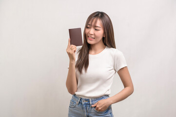 Naklejka premium Young happy asian tourist woman over white background studio, travel and holidays concept..