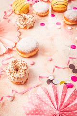 German Krapfen or donuts with streamers and confetti. Traditional Berliner for carnival and party