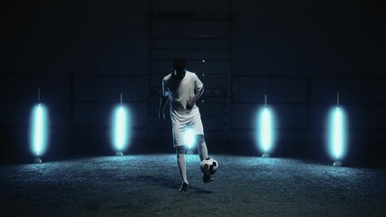 african athlete playing football alone at night, portrait of man practicing keepie uppie exercise