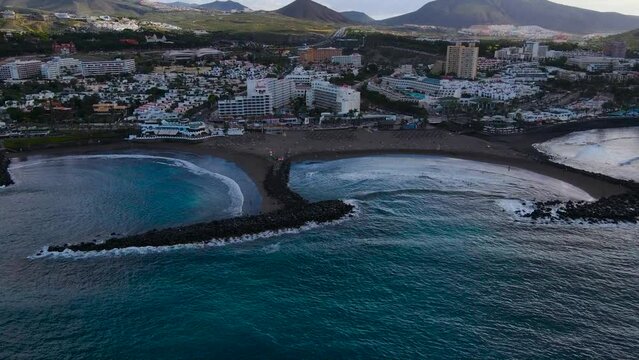 Troya beach Tenerife, breakwaters. The drone moves away from the coastline