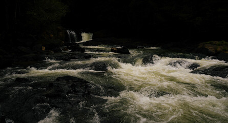 River stream waterfalls flowing over the rocks during late evening