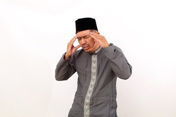 Asian muslim man suffering from terrible headache. Isolated on white background