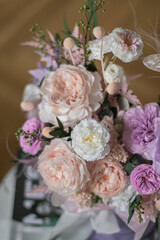 Beautiful box with peonies and roses in a purpl box on coffee table. Bouquet of tenders peonies a girl for mother's day, valentine's day, Woman's day 8 march.