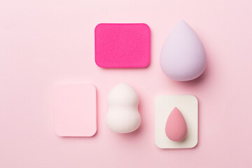 Beauty blenders on color background, top view