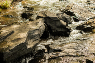 River water stream flowing on the rocks.