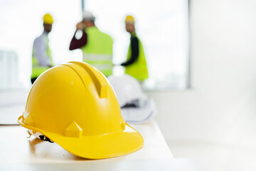 Yellow helmets and tablet computers on table in office center. Engineer team to start new...