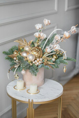Beautiful winter Christmas floral composition of fresh Nobilis in hat box. Cotton, spruce, sparkling ornaments. Holiday concept. Happy New Year decorations.