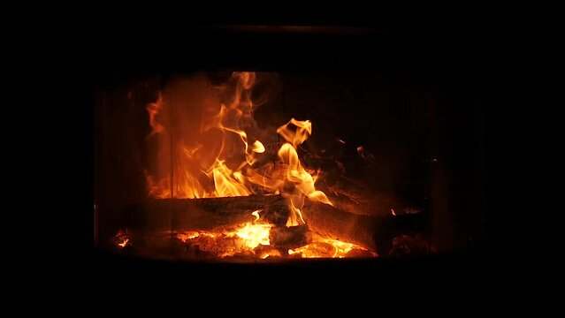 fire in a fireplace with dark background in slow motion 180 fps