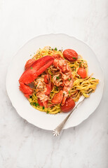 Lobster linguine  pasta  on the white marble  table. Delicatessen, rare seafood pasta recipe. Sardinia, Sicilian, Neapolitan cuisine. Italian and French food. Top  view - 558161534