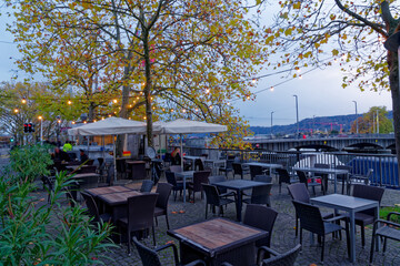 Couple enjoying late autumn afternoon sitting at Gelateria at Bellevue Square at City of Zürich. Photo taken November 4th, 2022, Zurich, Switzerland.