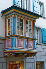 Fototapeta premium Beautiful colorful wooden oriel at historic house at the old town of Zürich on a cloudy autumn day. Photo taken November 4th, 2022, Zurich, Switzerland.