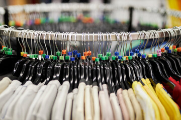 Close-up of a clothes hanger with tags for different European clothing sizes. hangers with clothing sizes, in a clothing store close-up. Shopping concept.
