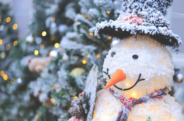 snow doll smiling face with mood and tone of winter in Christmas and new year eve. selective focus.