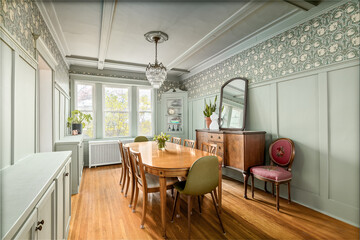 Vintage Dining Room with Transitional Aesthetic. Sage green wainscotting with antique pattern...