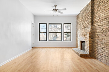 Clean and Bright Vacant Room. Vintage room with antique radiator and brick surround fireplace. Empty room for virtual staging with natural light.
