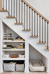 Modern Staircase with Open Storage Underneath. Aesthetic organization in small spaces. Metal stair railing with wooden bannister. - obrazy, fototapety, plakaty