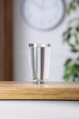 Glass of pure water on wooden table indoors