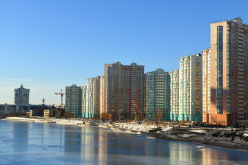 New buildings on snow-covered embankment of Moskva river in winter. Moscow, Russia