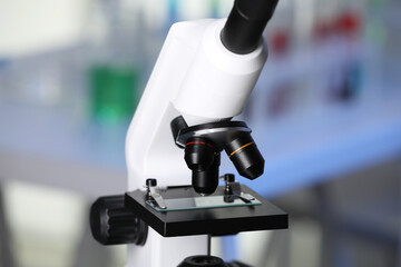 Modern medical microscope with glass slide in laboratory, closeup