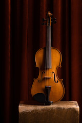 Old retro wooden violin on a background.