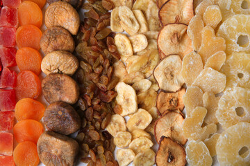 Different tasty dried fruits as background, top view