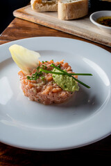 Tuna tartare. Raw Tuna dish that combines raw seafood, fish and a citrus sauce. Tuna is chopped in pieces and then mixed with the sauce. Tuna Tartare is traditional to Japanese cuisine.