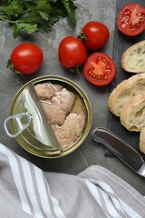 Flat lay composition with tin can of tasty cod liver and different products on grey table