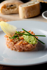 Tuna tartare. Raw Tuna dish that combines raw seafood, fish and a citrus sauce. Tuna is chopped in pieces and then mixed with the sauce. Tuna Tartare is traditional to Japanese cuisine.