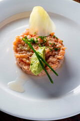 Tuna tartare. Raw Tuna dish that combines raw seafood, fish and a citrus sauce. Tuna is chopped in pieces and then mixed with the sauce. Tuna Tartare is traditional to Japanese cuisine.