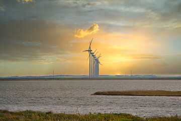 Some Wind turbines on a Fjord in Denmark, beautiful sunrise in Autumn