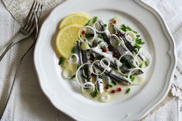 Filetti di sardine marinate in un piatto bianco. Filetti di sarda bianca. Frutti di mare sani. - obrazy, fototapety, plakaty