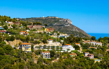 Obraz premium Panoramic view of Eze town valley among Alpes hills and residential area with summer houses and villas on French Riviera Coast of Mediterranean Sea in France