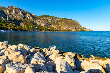 Panoramic view of Alpes mountains and slopes with Cap Estel Cape over Eze sur Mer resort town and beach on French Riviera Coast of Mediterranean Sea in France