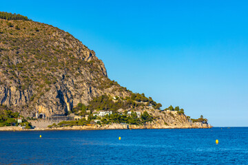 Panoramic view of Alpes mountains and slopes with Cap Estel Cape over Eze sur Mer resort town and beach on French Riviera Coast of Mediterranean Sea in France