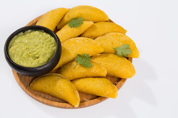 Colombian empanada with avocado sauce - on the white background.traditional colombian food