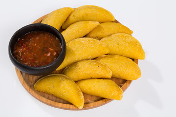 Colombian empanada with spicy sauce - on the white background.traditional colombian food