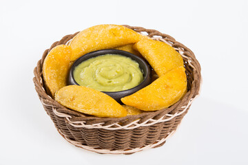 Colombian empanada with avocado sauce - on the white background.traditional colombian food