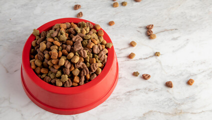 Top view of a bowl full of dog kibble. container filled with dry pet food