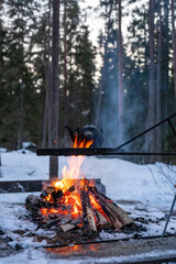 Old kettle boiling over an open fire outdoors in winter. Österbotten/Pohjanmaa, Finland