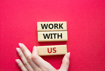 Work with us symbol. Wooden blocks with words Work with us. Businessman hand. Beautiful red background. Business and Work with us concept. Copy space.