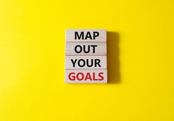 Goals symbol. Wooden blocks with words Map out your goals. Beautiful yellow background. Business and 'Map out your goals' concept. Copy space.