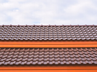 Orange tile roof on new house with blue sky