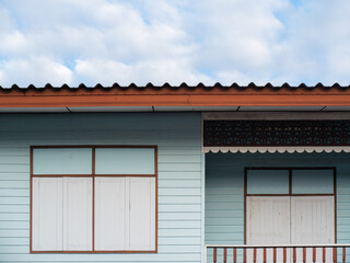 Facade of a vintage house with windows and sky background