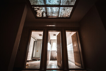 abandoned bathroom in a military barracks with a shower cubicle and a skylight in a lost place