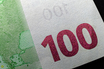 A macro of the hundred euro banknote, number 100 and copy space.