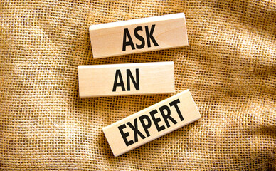 Ask an expert symbol. Concept words Ask an expert on wooden blocks on a beautiful canvas table canvas background. Business and ask an expert concept. Copy space.